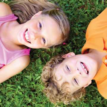Two children on lawn happy